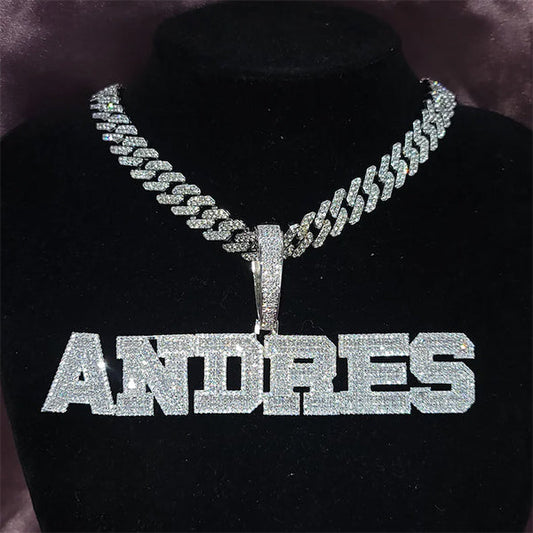 Iced out custom name pendant fully covered in cubic zirconia stones on black background — VibePlugs custom jewelry