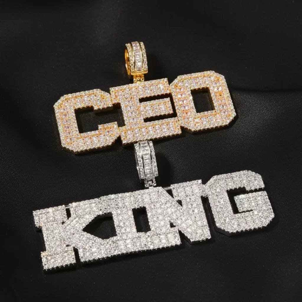 Gold and silver iced-out custom name pendants side by side — comparing gold-plated warm CZ sparkle vs rhodium silver-plated cool white CZ finish