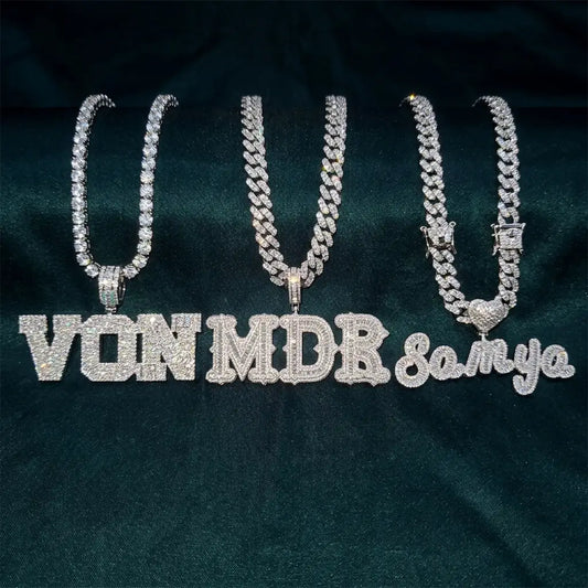 Three custom iced out name necklaces side by side — block letters, gothic letters, and cursive script — fully set with CZ stones on Cuban and tennis chains
