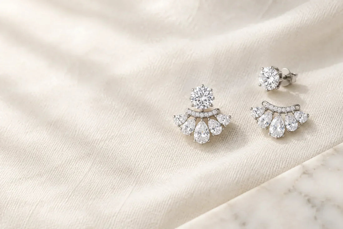 Pear cut CZ ear jacket earrings with round solitaire stud and removable jacket on ivory linen