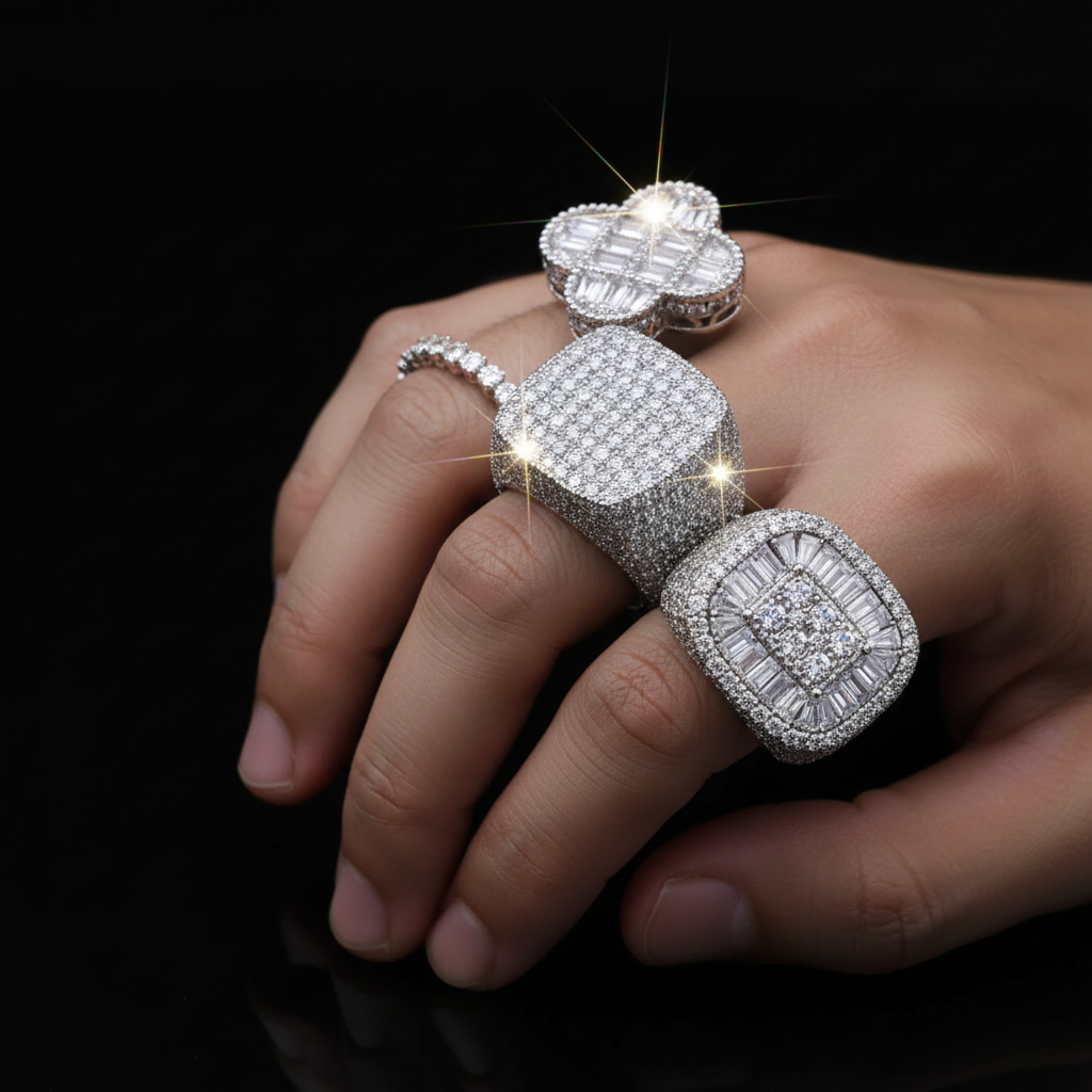 Five iced out CZ rings stacked together — clover, cube, heart, championship, and eternity band styles in silver
