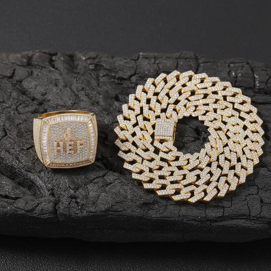 Men's gold signet ring paired with iced out Cuban chain on dark textured background